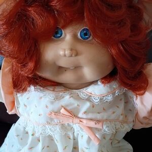 Adorable Red-Haired Doll with Peach Dress